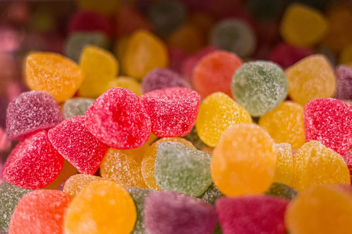 Close-up of dozens of sugar-coated gumdrops in red, orange, yellow, green and purple